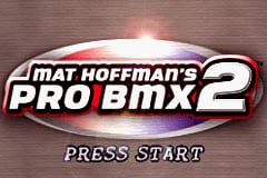 The title screen displays a chrome-effect logo reading 'MAT HOFFMAN'S PRO BMX 2' centered against a textured brown wooden background. Below the logo, white text reads 'PRESS START' in a bold sans-serif font. The overall design uses a metallic silver and red color scheme for the logo, creating a 3D appearance typical of GBA-era sports game aesthetics.