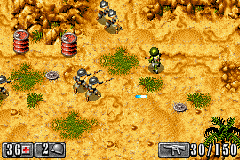 A top-down isometric view of a desert landscape with tan and yellow sandy terrain. Scattered green shrubs dot the ground. Several small sprite-based military units and structures are positioned across the map. The UI displays a health bar and ammunition count in the lower left corner reading "3 of 4" and "2", while the lower right shows "500/1150", likely representing resources or unit counts. The overall color palette is warm earth tones with minimal saturation, typical of GBA-era graphics.