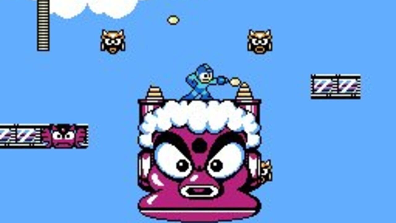 A large pink robot boss with white fluffy hair and an angry expression dominates the center of the screen. Mega Man in blue armor stands on top of the boss's head, firing a yellow projectile. Two smaller enemy heads with tan and brown coloring float in the upper portion against a blue sky with white clouds. Pixelated ZZ-pattern barriers appear on the left and right sides of the screen. The overall scene is rendered in NES-era sprite graphics with a bright color palette.