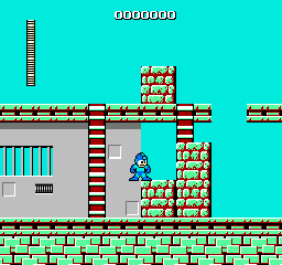 Mega Man stands on a gray platform in the center of a bright cyan stage. Red brick blocks form walls and structures to the right, while cyan vertical railings appear on the left side. Green brick platforms line the bottom of the screen. A small white rectangular door or building structure sits on the left platform. The stage uses a limited palette of cyan, red, gray, green, and white pixels in a typical NES resolution sprite style.