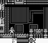 Mega Man stands on a platform in the left-center of a monochrome Game Boy level, rendered in low-resolution blue and white pixels. Vertical and horizontal lines form industrial architecture around him, with stairs visible in the background. A small UI element appears in the lower-left corner. The screen displays typical Game Boy hardware-era pixelation and limited palette, showing a single-screen platformer stage layout with solid geometry and the protagonist in idle or ready stance.