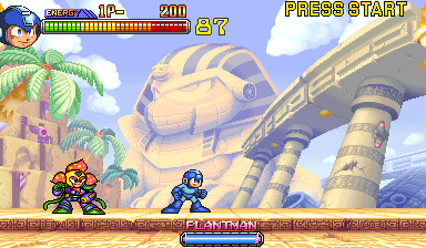 Two pixelated characters stand on a brown platform in the foreground against a desert landscape with blue sky and white clouds. A large mechanical robot head dominates the background to the right, with tan-colored metallic plating and dark details. Palm trees and ornate architecture visible on the left. The HUD displays health bars, a score counter reading 2200, and a "PRESS START" prompt in the upper right corner. The bottom of the screen shows a brown banner with "PLANTMAN" text centered.