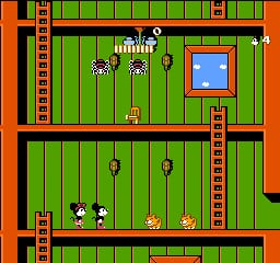 A vertically stacked two-room interior level with bright green walls and orange-red trim. The upper room displays a wood-patterned floor with two character sprites (Mickey and Minnie) positioned left and center, three hanging rope objects above them, and a blue window on the right wall. The lower room shows two character sprites on a similar wood floor with three additional rope objects suspended above. Both rooms feature vertical orange pipes along the sides and black horizontal girders separating the sections. The pixel art uses a limited 8-bit color palette typical of NES-era graphics.