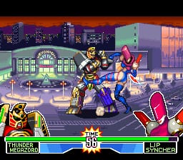 Two characters face off against a large robotic opponent in an urban street setting at dusk. The player character wears blue armor on the left, while the opponent in pink stands on the right. A tall building with glowing windows and a red-roofed structure frame the background. The HUD displays player health bars at the bottom, with pixelated sprite-based characters rendered in the SNES-era 16-bit art style. The ground features a sidewalk with metal barriers, and the scene is lit by warm sunset colors reflected across the urban environment.