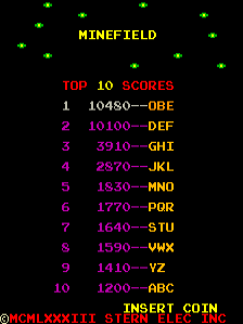 The title screen displays 'MINEFIELD' in yellow pixel text at the top, surrounded by green asterisks scattered across a black background. Below are two sections: a red 'TOP 10 SCORES' header followed by ten numbered rows listing rankings with initials and point values in magenta and cyan text. At the bottom, yellow text reads 'INSERT COIN' with additional text partially visible below it in a smaller font.