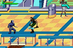 Two dark-suited figures run across a yellow platform level with blue diagonal stripes dividing the walkways. The upper figure moves along the top platform while the lower figure traverses the bottom section. A gray cylindrical structure stands in the background, and health bars appear at the top of the screen in green and yellow. The pixel art uses a limited color palette of yellow, blue, black, and purple tones typical of GBA-era graphics.