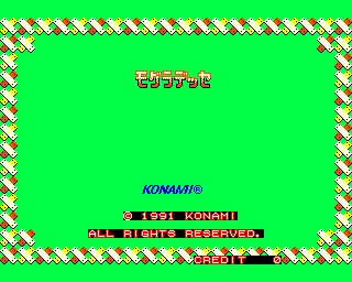 A bright green background is framed by a diagonal striped border in white, yellow, and red. Red Japanese text reading "モグラデッセ" (Mogura Desse) appears centered near the top. Below that, blue text reads "KONAMI©" followed by white and red text displaying "(C) 1991 KONAMI" and "ALL RIGHTS RESERVED." At the bottom, red text shows "(C)1991 KONAMI". The screen uses a limited 8-bit pixel art color palette typical of early 1990s arcade hardware.