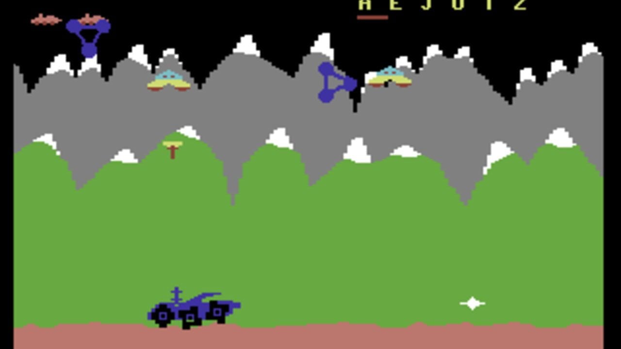 A blue lunar rover vehicle sits in the tan soil at the bottom center of the screen, facing right. Gray and white jagged mountains with snow-capped peaks fill the upper half against a black sky. The word 'REJUTZ' appears in yellow text at the top. Green rolling hills occupy the middle ground with white clouds dotting the gray mountain backdrop. Three yellow-windowed aircraft hover in the upper portion, with one blue projectile visible mid-screen. A small white diamond shape appears in the lower right area. The palette consists of bright green, gray, white, tan, and blue pixel-art sprites typical of early 1980s arcade games.