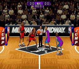 Two basketball players in red and purple uniforms face each other at center court on a wooden arena floor. A scoreboard displays 00:16 00 at the top. Spectators fill the background bleachers. Midtown and Midway advertising boards line the court perimeter. The sprite-based graphics show low resolution pixelated player models typical of 16-bit basketball games, with a tan-colored hardwood court rendered in the isometric perspective common to SNES sports titles.