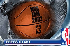 A basketball occupying the center of the screen displays "NBA JAM 2002" in black text. The ball sits on a textured gray surface with snow or frost visible at the top edge. Below the basketball, a blue banner spans the width of the screen with "PRESS START" in white text on the left side and the NBA logo in red and blue on the right. The overall composition presents a winter-themed title screen with an orange ball as the focal point against cool-toned background elements.