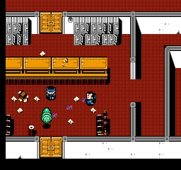 A top-down view of a red brick building interior shows a Ghostbuster character sprite in the center with a proton pack, surrounded by scattered debris and white ghost sprites. Yellow rectangular platforms line the upper and lower walls. Dark gray pillars divide the space vertically. A yellow doorway appears in the top-left corner. The pixel art uses a limited NES color palette with red dominanting the floor, yellow for architectural elements, and white and black for details. Scattered white dots suggest collectible items or supernatural activity across the room.