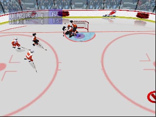 A hockey rink viewed from above shows a red team and blue team in play, with the red team in possession near the blue team's goal. A goaltender in blue occupies the crease while red players position themselves for a scoring attempt. The scoreboard at top left displays team scores and game time. Rink boards with advertising panels line the perimeter, and the ice surface features pink-outlined circles marking the center and goal areas. The 3D-rendered graphics display the pixelated aesthetic typical of Nintendo 64 sports titles.