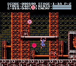 A ninja protagonist stands in a red brick corridor with ornate architectural details, facing a pink spherical enemy projectile. The top-left displays the HUD with score 000100, stage 1-4, and health bar represented by character portraits. The stage features a symmetrical castle interior with rust-colored brick walls, decorative columns, and a tiled floor pattern. Sprite-based visuals use a limited color palette typical of NES hardware, with the ninja rendered in blue and the enemy projectiles in bright pink against darker background elements.