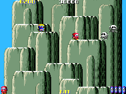 A vertical scrolling platformer stage features tall green cactus formations arranged across a blue sky background. A ninja character in red appears near the top-center, while a character in blue occupies the lower-left corner. White skull icons and numerical score displays (28860 and 9690) are positioned in the upper corners, with additional UI elements visible at the screen edges. The sprite-based graphics use a limited color palette typical of mid-1980s arcade hardware.