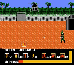 A top-down view of a military compound with orange brick walls and green vegetation visible at the top. A soldier in green stands in the center-right of the compound, facing another armed figure on the left. An arched gate structure is visible at the top center. The HUD displays a score of 0000350 at the top left, with weapon and ammunition indicators shown as small icons across the bottom of the screen in a horizontal bar.