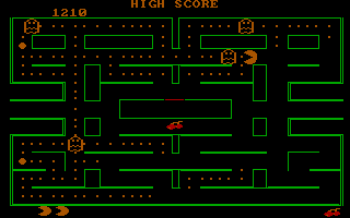 A green-and-black pixelated maze level displays a score of 1310 at the top. Pac-Man appears as a yellow character in the center-right area, while four colored ghosts—red, pink, blue, and orange—are scattered throughout the corridor-based maze layout. The playfield features narrow passages, open corridors, and small square pellet patterns in dotted lines. Score panels frame both left and right edges of the screen. The overall visual style uses vector-like green lines on a black background, characteristic of early arcade port aesthetics.