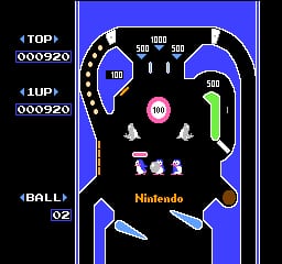 A pinball table displays a vertical NES-era layout with a blue border frame. The playfield features a black background with a central ramp design, colored bumpers in blue and red, and flipper mechanisms at the bottom. Score readouts appear on the left edge, showing "TOP" and "UP" values, along with a "BALL" counter displaying "02". The "Nintendo" logo is visible in the lower center area. Pixel-art style graphics include small character sprites and white dotted lane guides marking the ball's path across the table.
