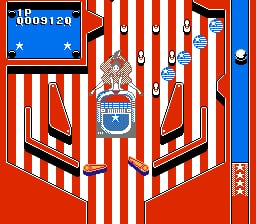 A pinball table features red and white striped walls forming a V-shaped lane pattern typical of pinball gameplay. At the center top sits an ornate brown and blue bumper or ramp structure. Blue flippers are positioned at the bottom corners of the playfield. Red vertical elements frame both sides of the table, with a blue vertical score or level indicator strip visible along the right edge. The overall aesthetic uses a limited NES-era color palette of red, blue, white, brown, and black.