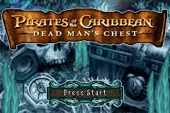 The title screen displays 'Pirates of the Caribbean: Dead Man's Chest' in ornate gold lettering at the top against a dark teal background with atmospheric ice or frost textures. Below the title, a skeletal ship's wheel in white and gray sits centered, with a glowing blue circular emblem behind it. At the bottom, a green 'Press Start' button prompt appears on a wooden plaque design. The overall color scheme emphasizes cool blues and teals with warm gold accents, rendered in Game Boy Advance's characteristic low-resolution sprite graphics.