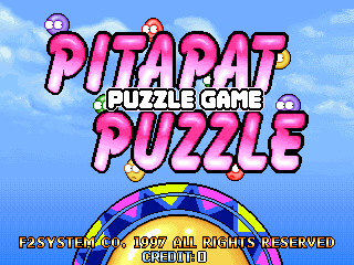 The title screen displays "PITAPAT PUZZLE" in large pink pixelated letters against a blue cloudy sky background. Small colorful spheres float around the text. Below the title sits a circular puzzle wheel with alternating colored segments in red, blue, and yellow. At the bottom, yellow text reads "PLAY THE MAGIC 1997 ALL RIGHTS RESERVED OPERATION!" The art style features bright colors and 16-bit sprite graphics typical of 1990s arcade games.