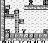 A Game Boy-style level layout displays a maze-like arena with brown stone blocks arranged in a grid pattern. A small white character sprite stands in the center area, surrounded by destructible crates and permanent walls. The top-right corner shows a score display reading "03:54" and "d2 Y4 d1 d1", indicating time and game status information. The monochrome pixel art uses the typical Game Boy palette of blacks, whites, and grays with minimal animation frames visible.