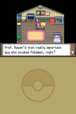 A pixelated interior scene shows a character standing in the center of a house with gray wooden walls and beige flooring. The room contains various furniture items arranged around the perimeter, including desks with computer monitors in the upper corners, shelving units, a bed, and a large pink rectangular object. A dialogue box at the bottom displays text referencing Professor Rowan and Pokémon studies. A large Poké Ball icon is faintly visible in the lower half of the screen against a tan background.