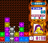 A puzzle game board fills the left side, displaying a grid of colored blocks in purple, green, blue, and yellow arranged in rows. A small pixelated character sprite appears in the center-lower area. The right side shows a UI panel with an "EASY" difficulty setting at top, score display reading "SCORE 0", and a timer showing "2:00" in white text on blue background. A character portrait with purple coloring is visible in the lower-right corner. A time counter displays "03:03" at the bottom center. The overall art style uses low-resolution 8-bit sprites and a red-orange textured background.