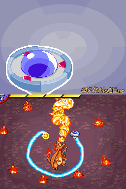 A split-screen gameplay view shows Pokémon Ranger's capture mechanic. The upper screen displays a large blue eye icon with a white circular crosshair overlay and colored directional segments. The lower screen shows a brown terrain area with a yellow and orange fire-type Pokémon surrounded by a blue circular capture ring. Multiple small red flame particles scatter across the dark ground, and a level indicator reading "ADVANCE" appears in the upper-left corner.