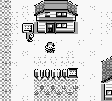 A Game Boy screenshot displaying a two-story house structure with windows and a door in the upper portion, rendered in monochrome green-tinted pixels. Below the house sits a inventory or item menu grid showing six filled slots arranged in a 3x2 pattern, with text labels beneath each icon. The background is a light gray with visible scan lines typical of Game Boy hardware. A small circular icon appears centrally between the house and menu sections.