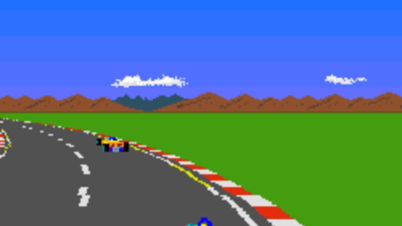 A top-down racing view shows a blue race car positioned in the middle of a gray asphalt road marked with white dashed center lines and red-and-white boundary markers. The road curves into the distance with a yellow-and-white dotted line on the right edge. Green grass flanks both sides of the track, with brown and green mountains visible along the horizon against a bright blue sky dotted with white clouds. A checkered flag pattern appears in the upper left corner. The scene uses 8-bit pixel graphics with a limited color palette typical of 1980s arcade-style racing games.