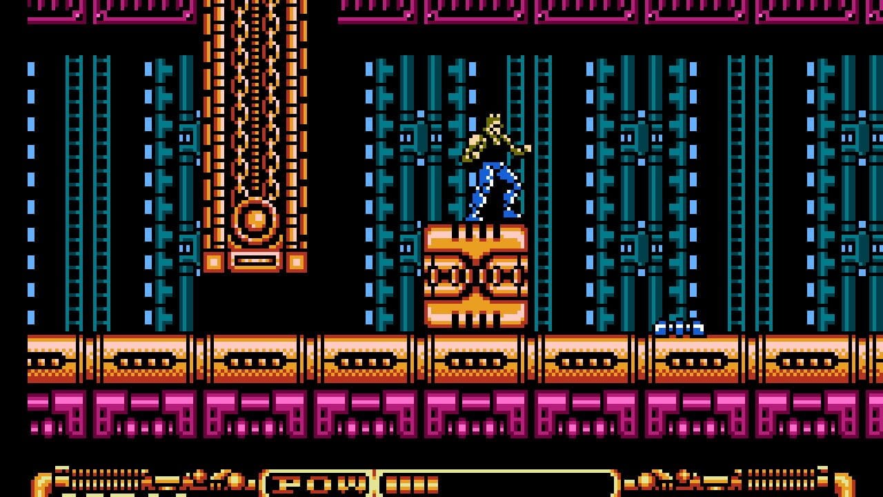 A blue-clad character with blonde hair stands atop an orange platform structure in the center of a futuristic cityscape. Tall cyan and blue pixelated buildings with window patterns fill the background on both sides. Orange and yellow metallic architectural elements frame the central tower. A magenta-pink floor with geometric patterns runs across the bottom of the screen, with an orange beam structure above it. Small white projectiles visible in the distance. The NES-era pixel art uses a limited color palette of blue, cyan, orange, magenta, and black against a black background.