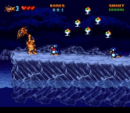 A caveman character stands on the left side of a pixelated ice or rocky terrain, facing right toward several white ghost-like enemies scattered across the upper portion of the screen. The background features a blue night sky with layered parallax scrolling showing distant terrain. The HUD displays three red health bars in the top-left corner, a score counter reading "0" at top-center, and "SHORT" with a number in the top-right. The sprite work shows 16-bit SNES-era resolution with a cool color palette of blues and whites dominating the icy level setting.