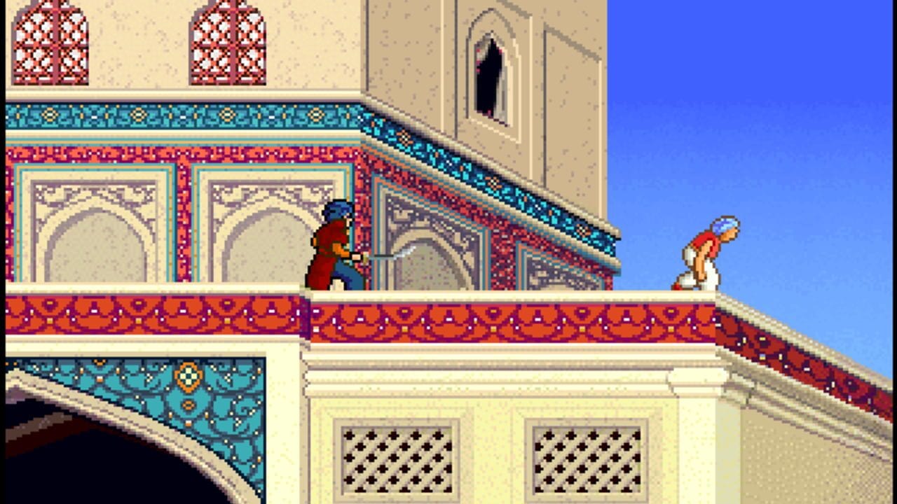 A character in red and blue clothing stands on a decorated rooftop ledge with ornate turquoise and crimson patterned borders. An opponent in white and orange clothes crouches on the right side of the roof. The architecture features cream-colored walls with geometric relief patterns, red decorative windows with lattice designs, and domed elements typical of Middle Eastern palace design. Clear blue sky fills the right portion of the screen. The pixel art uses a 256-color DOS palette with visible sprite-based character animation against the isometric architectural background.