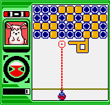 The left side of the screen displays a vertical control panel with a small character portrait in a green frame at the top and a circular spinner dial below it. The main gameplay area shows a grid of colored spheres in blue, orange, yellow, and other hues arranged in rows. A purple ball sits at the bottom center with a dotted red line extending upward, indicating aiming or trajectory mechanics. The interface uses a bright, 8-bit pixel art style typical of Neo Geo Pocket Color hardware.
