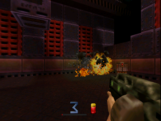 A first-person view shows a player's green-textured weapon in the lower right corner of the screen. In the center, a large yellow and orange explosion erupts from a floor-level impact. The industrial environment features red metal grilles and walls with brown-orange paneling. A blue ammo indicator and health/armor bars appear in the lower left corner. The low-polygon 3D graphics and muted color palette are characteristic of N64-era shooters.