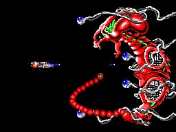 A spaceship fires a red energy beam trajectory across the black screen toward a large red mechanical enemy on the right side. The player's small white craft appears in the upper left, while the enemy sprite features multiple red segments with metallic details and protrusions. Red projectile arcs trace the beam path between the two objects against the stark black background.