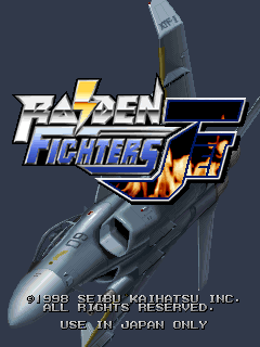The title screen displays the Raiden Fighters Jet logo in large yellow and blue text positioned in the upper center, overlaid on a detailed grayscale image of a military jet aircraft viewed from above at an angle. Below the logo sits a stylized orange and yellow flame graphic. Copyright text reading '©1998 SEIBU KAIHATSU INC. ALL RIGHTS RESERVED.' and 'USE IN JAPAN ONLY' appears in white pixelated font at the bottom of the screen against a dark gray background.
