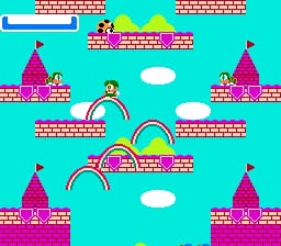 A bright cyan sky fills the background as a player-controlled character in light blue stands in the center of the screen. Pink and magenta castle structures with red flags anchor the corners and edges of the level. Colorful rainbow-arched bridges connect different platforms, rendered in pink, purple, and cyan. White clouds float in the upper portion. Tall pink brick towers with windows sit in the upper left and right. The overall sprite resolution shows 8-bit pixelation typical of NES graphics, with a vibrant pastel color palette dominating the scene.