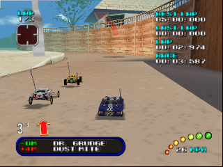 A top-down view of a sandy racing track with four miniature vehicles positioned across the terrain. The track features brick walls along the perimeter and a geometric layout with multiple sections. The HUD displays race position, lap count, and speed data in the lower portion. A map thumbnail appears in the upper right, and colored icons representing multiple racers line the right edge. The vehicle in first position is highlighted in the foreground, rendered in blue with visible chassis details characteristic of N64-era 3D graphics.