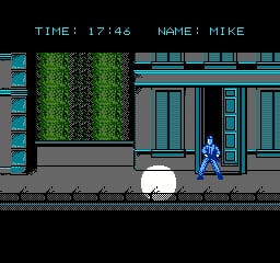 A blue-clad player character stands on a sidewalk in front of a building with green-tinted foliage above its entrance. The UI displays "TIME: 17:46" and "NAME: MIKE" in yellow text at the top. The building features blue-gray paneled walls and a door entrance. The scene uses the NES's 8-bit sprite style with limited color palette of blues, grays, and greens set against a black background.