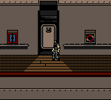 A character stands on a horizontal deck or corridor with a tan-colored wall backdrop. The figure is centered in the frame, rendered in low-resolution pixels typical of Game Boy hardware. Three dark rectangular openings—a door in the center and windows on either side—are visible on the upper wall. The environment uses a limited color palette of browns, grays, and blacks characteristic of Game Boy Advance graphics. The scene appears to be an indoor shipboard or industrial location with a flat, side-scrolling perspective.
