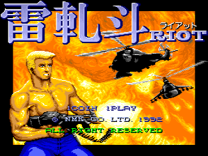 The title screen displays "Riot" in large orange and blue pixelated lettering at the top. Below sits a muscular shirtless man with a tan complexion positioned on the left side, wielding an assault rifle. To his right, a black helicopter hovers against an orange and yellow fiery background. At the bottom, white text reads "1PLAY" on the left, "NMK LTD. 1992" in the center, and "TECMO" on the right. The color palette is dominated by warm tones of orange, yellow, and black, typical of early 1990s arcade game graphics.