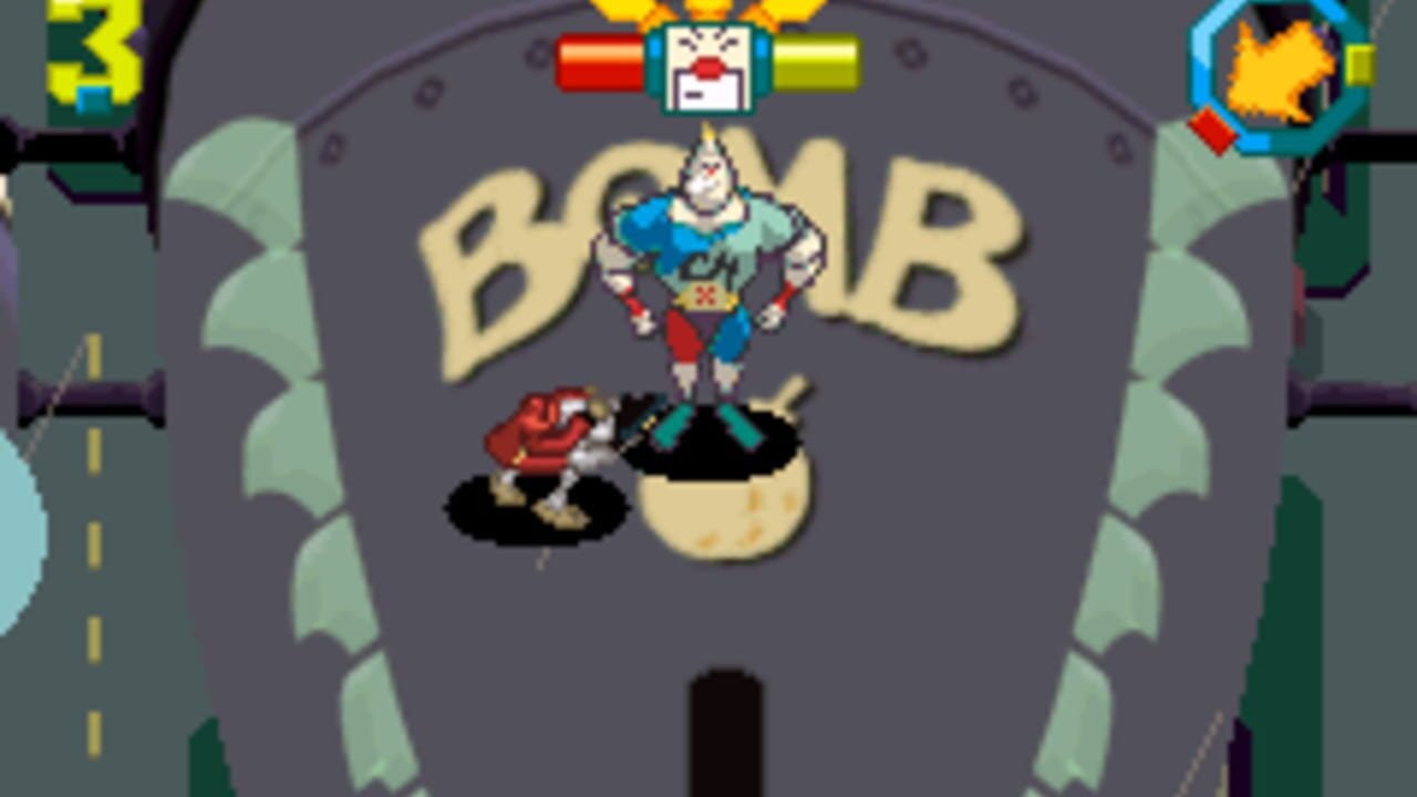 A large character in blue and red clothing stands centered in a cream-colored egg or pod shape with the letters 'BOMB' displayed above in yellow. Two smaller red and black creatures appear on either side of the egg against a gray background. Health bars in red and yellow display at the top of the screen, with a character portrait in a blue frame visible in the upper right corner. The scene uses bright pixel art sprites typical of Game Boy Advance games, with green foliage shapes flanking the left and right edges of the screen.