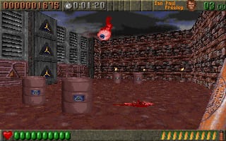 A first-person shooter view displays a brown brick arena with a red-roofed structure in the center distance. The player character holds a weapon visible in the lower right. A vertical weapon/item HUD panel occupies the left side showing multiple weapon icons. Health and ammo bars run along the bottom in green and yellow segments. The score reads 0001:20 at top left. Atmospheric fog and distant architecture create depth in the background.