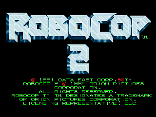 The Robocop 2 arcade title screen displays the game logo in large pixelated blue lettering at the top center against a black background. Below the title sits a smaller "2" in matching blue text. Green copyright text lines appear in the lower portion, listing 1991 Data East Corporation and copyright information for Robocop and Data East Corporation, along with licensing details for Ocean. The entire interface uses low-resolution bitmap fonts typical of early 1990s arcade cabinets.