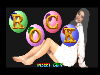 A woman in a white sleeveless top and gray hair sits with her legs extended, positioned right of center against a dark background. Four large colored circles float above her containing yellow letters spelling "ROCK": a green circle with red "R", a pink circle with yellow "O", a pink circle with yellow "C", and a blue circle with yellow "K". Green text reading "INSERT COIN" appears at the bottom of the screen. The graphics use bright, saturated colors typical of early 1990s arcade aesthetics.