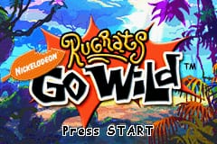 The title screen displays the Nickelodeon Rugrats Go Wild logo prominently in the center, rendered in white and magenta text with a stylized font. Behind the logo stretches a vibrant tropical jungle scene with blue sky, purple and green palm trees, orange rock formations, and warm earth tones. The Nickelodeon logo appears in the upper left corner. A "PRESS START" prompt is positioned at the bottom of the screen in white text. The overall art style uses bright, saturated colors typical of Game Boy Advance graphics, with sprite-based jungle elements arranged in a layered background.