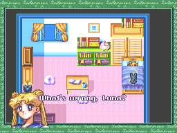 A bedroom interior displayed in a top-down view shows a character with blonde hair in the lower-left corner wearing a pink outfit. The room contains a blue bed with orange pillows in the upper-left, wooden furniture including shelves with books and items, and pink flooring. A text box with white Japanese characters appears at the bottom center of the screen. The interface uses a green decorative border frame around the gameplay area, with a dark background behind it. The art style displays 16-bit pixel graphics typical of SNES RPGs.
