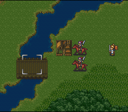 A tactical battlefield map displayed in isometric perspective shows a wooden fortification on the left bank of a blue river, with green terrain dotting the landscape. Two armed soldiers stand in the center-right area, while a third figure appears on the right side. The scene uses 16-bit sprite graphics with a muted earth-tone palette for terrain, contrasting with darker water and brighter unit sprites.