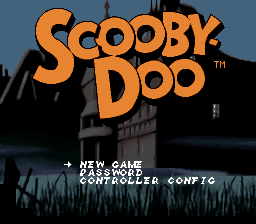 The title screen displays 'SCOOBY-DOO' in large orange pixel letters against a dark blue sky. A spooky mansion silhouette in black occupies the background, with bare trees flanking the structure. Below the title, white text lists three menu options: 'NEW GAME', 'LOAD GAME', and 'CONTROLLER CONFIG'. The overall color palette uses dark blues, blacks, and bright orange, creating a haunted atmosphere typical of 16-bit SNES graphics.